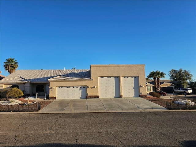 2084 E Crystal Dr, Fort Mohave, AZ 86426 - view of front facade featuring stucco siding, an attached garage, and concrete driveway