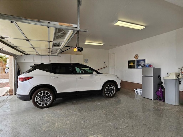 2084 E Crystal Dr, Fort Mohave, AZ 86426 - garage featuring freestanding refrigerator and a garage door opener
