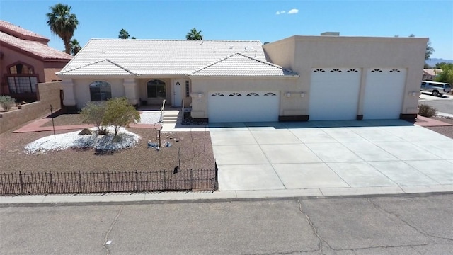 2084 E Crystal Dr, Fort Mohave, AZ 86426 - view of front of property with stucco siding, an attached garage, fence, and a tile roof