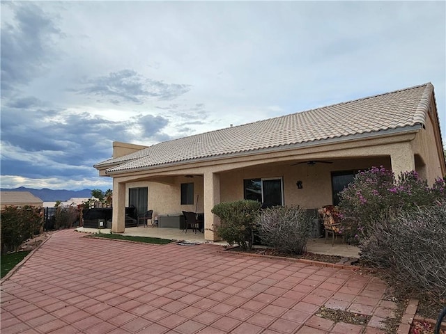 2084 E Crystal Dr, Fort Mohave, AZ 86426 - back of property featuring a ceiling fan, a patio area, stucco siding, and a tile roof