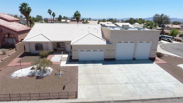 2084 E Crystal Dr, Fort Mohave, AZ 86426 - view of front of house featuring a garage, stucco siding, a tile roof, driveway, and a mountain view