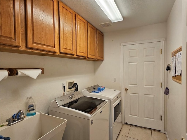 2084 E Crystal Dr, Fort Mohave, AZ 86426 - washroom featuring independent washer and dryer, cabinet space, and light tile patterned floors