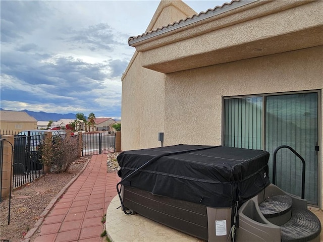 2084 E Crystal Dr, Fort Mohave, AZ 86426 - view of patio / terrace with fence, a gate, a hot tub, and a mountain view