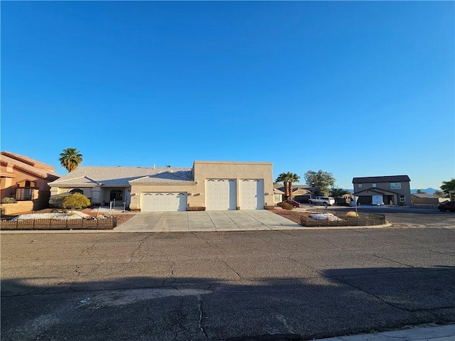 2084 E Crystal Dr, Fort Mohave, AZ 86426 - view of front facade featuring concrete driveway, stucco siding, a garage, and a residential view
