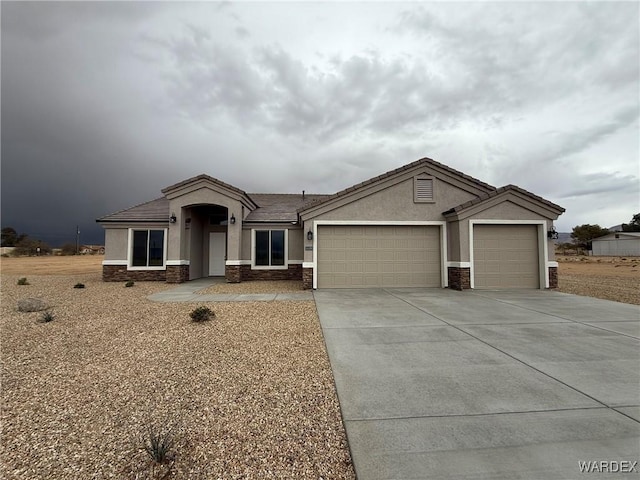 ranch-style house featuring driveway, stucco siding, stone siding, and an attached garage
