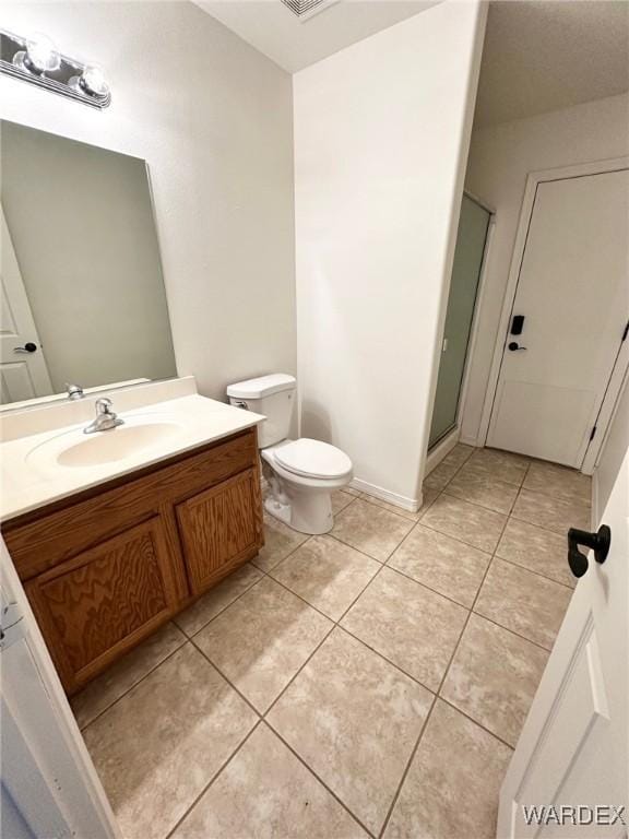 full bath with a shower stall, tile patterned floors, vanity, toilet, and visible vents