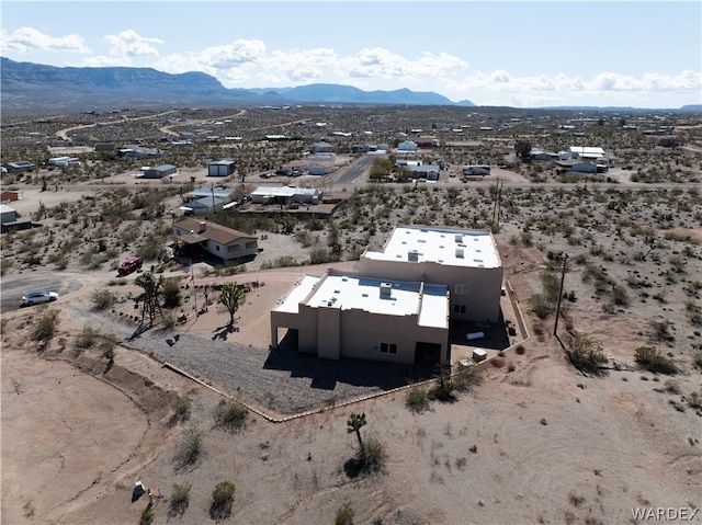 birds eye view of property with a desert view and a mountain view