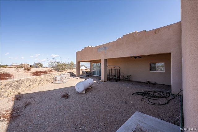 view of yard featuring ceiling fan and a patio