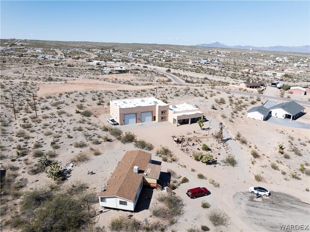 aerial view featuring a mountain view and a desert view