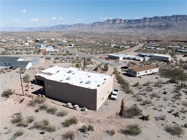 drone / aerial view featuring view of desert and a mountain view