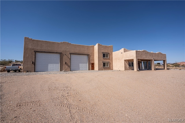 pueblo-style house with a garage