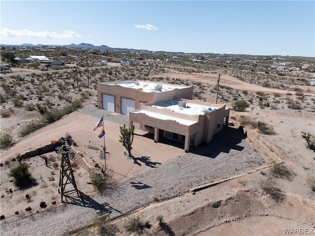 drone / aerial view featuring view of desert and a mountain view