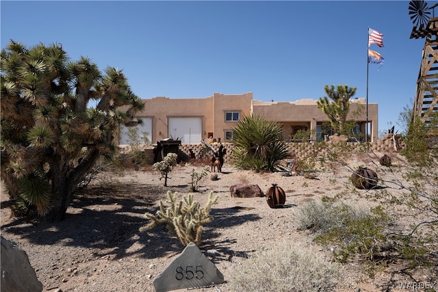 pueblo-style home featuring stucco siding