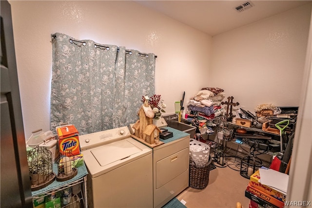 washroom with laundry area, washer and clothes dryer, and visible vents