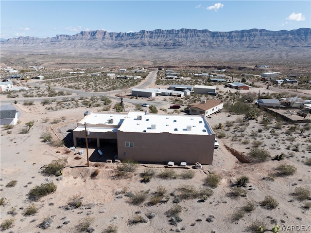 aerial view featuring a desert view and a mountain view