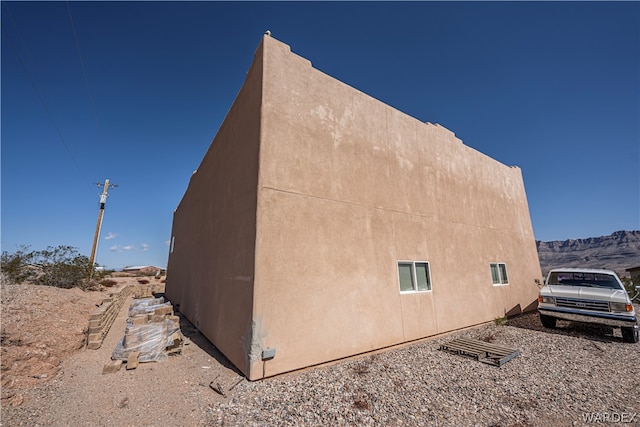 view of property exterior with a mountain view and stucco siding