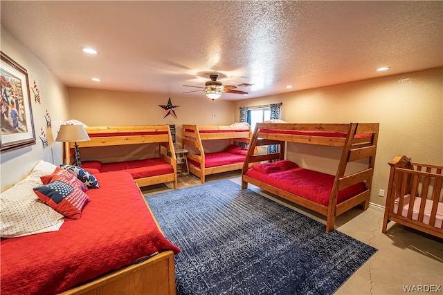 bedroom with a ceiling fan, a textured ceiling, and recessed lighting