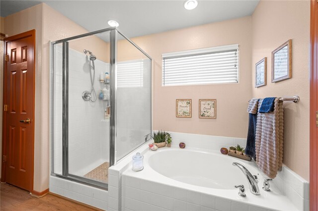 3854 Heather Ave, Kingman, AZ 86401 - bathroom featuring a bath, a stall shower, and wood finished floors