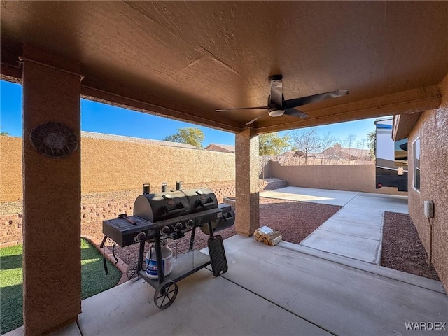 view of patio / terrace with a fenced backyard, ceiling fan, and grilling area