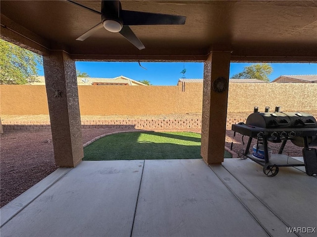 view of patio featuring a fenced backyard, a ceiling fan, and area for grilling