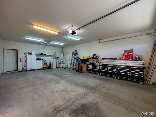 garage featuring a workshop area, gas water heater, and a garage door opener