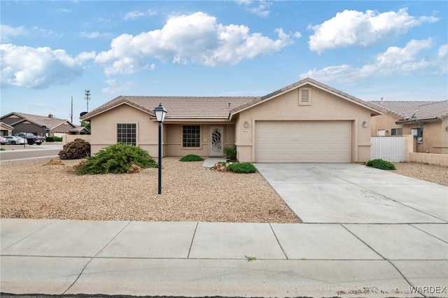 single story home featuring concrete driveway, stucco siding, an attached garage, and fence