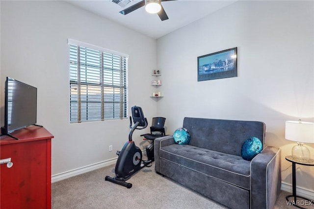 workout area with a ceiling fan, light colored carpet, visible vents, and baseboards