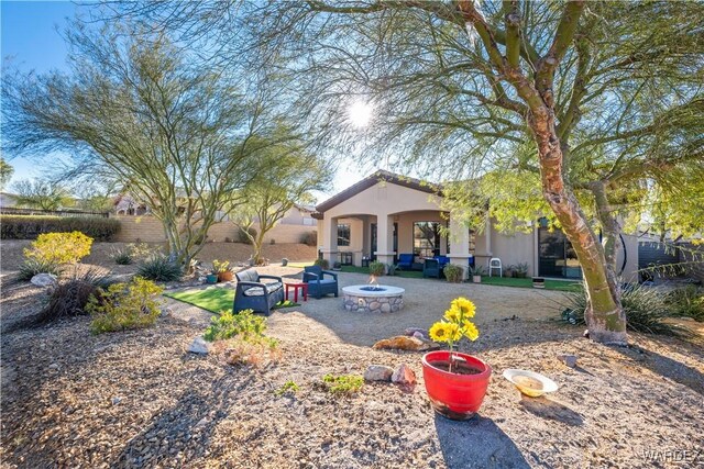 view of yard with an outdoor fire pit, fence, and a patio