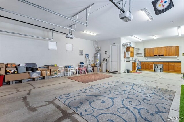 garage with a garage door opener and water heater