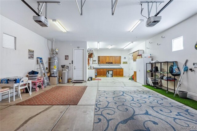 garage with a garage door opener and water heater