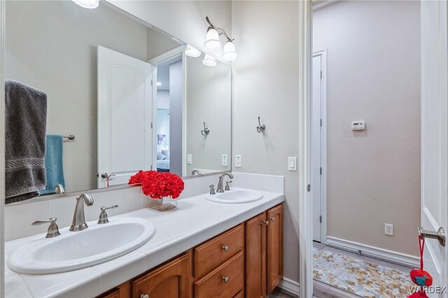 bathroom with double vanity and a sink