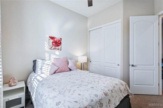 carpeted bedroom with a ceiling fan and a closet