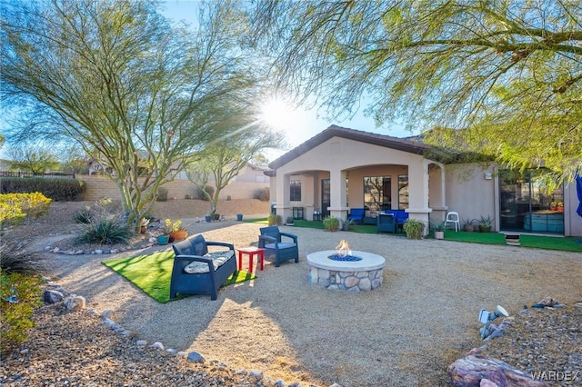 exterior space featuring an outdoor fire pit and a fenced backyard