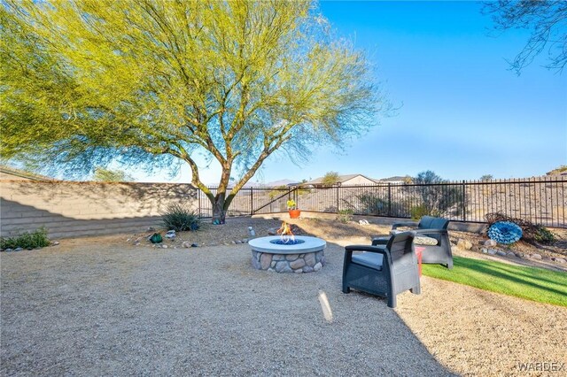 view of yard featuring an outdoor fire pit and a fenced backyard