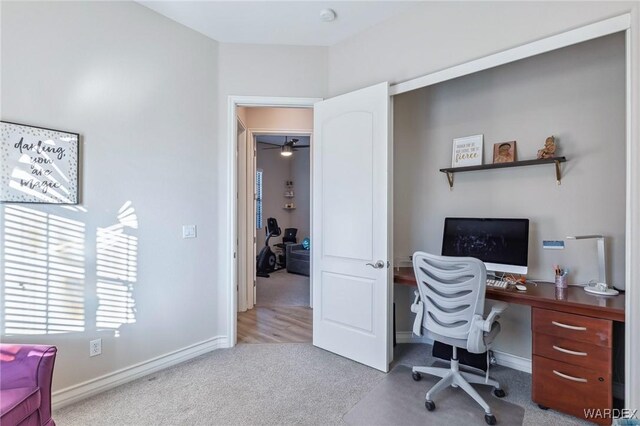 office space with light carpet and baseboards