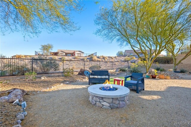 view of yard featuring an outdoor fire pit and a fenced backyard