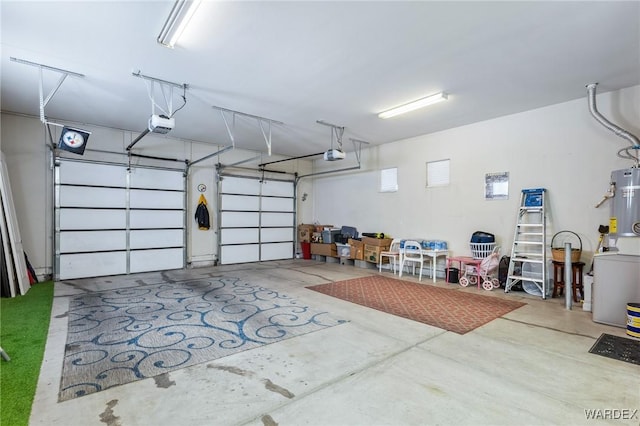 garage with water heater, washer / clothes dryer, and a garage door opener