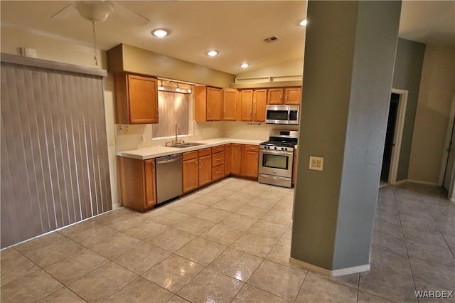 kitchen with visible vents, appliances with stainless steel finishes, brown cabinets, light countertops, and a sink