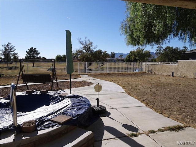 view of patio featuring fence