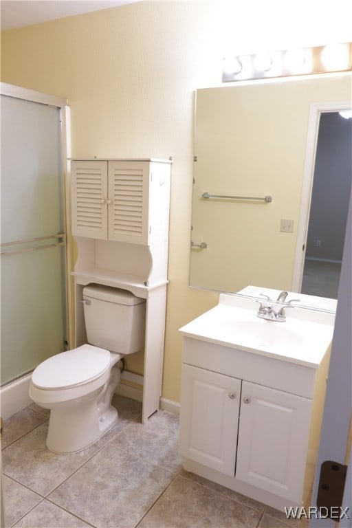 full bathroom featuring toilet, tile patterned flooring, a shower stall, and vanity