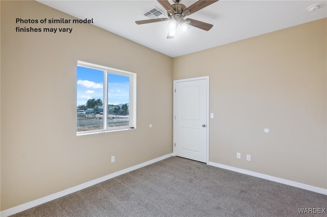 carpeted spare room featuring ceiling fan, visible vents, and baseboards