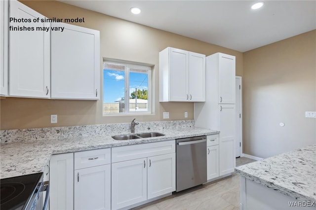 kitchen featuring appliances with stainless steel finishes, white cabinetry, and a sink