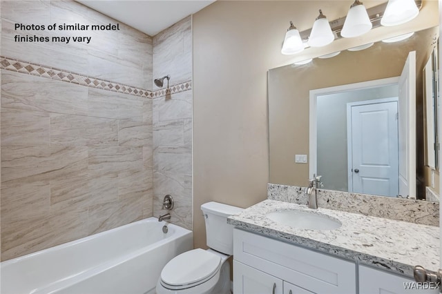 bathroom with washtub / shower combination, vanity, and toilet