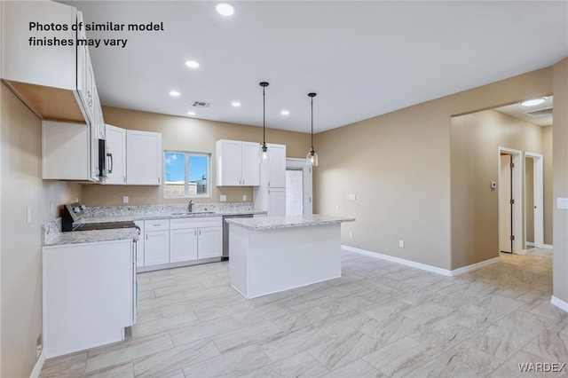 kitchen with visible vents, white cabinets, a kitchen island, hanging light fixtures, and stainless steel appliances