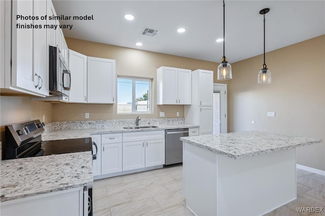 kitchen featuring appliances with stainless steel finishes, visible vents, a sink, and white cabinetry