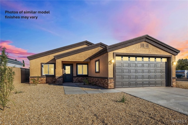 single story home featuring a garage, stone siding, concrete driveway, and stucco siding