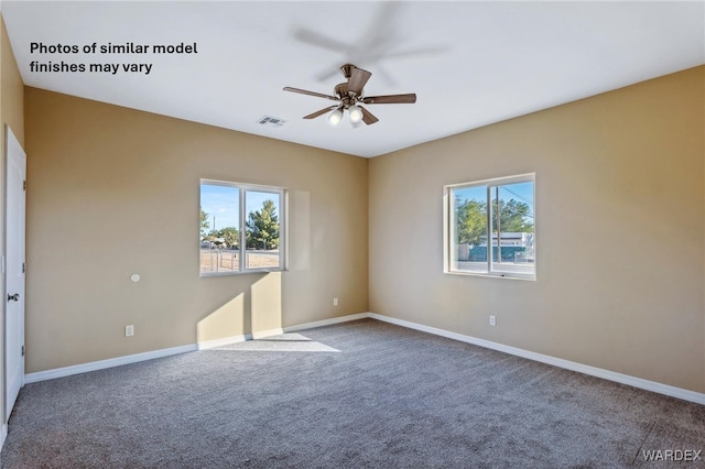 carpeted empty room with ceiling fan, plenty of natural light, visible vents, and baseboards