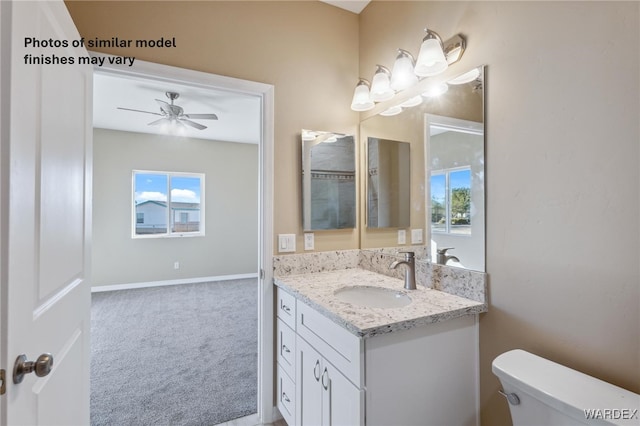 bathroom featuring a ceiling fan, baseboards, vanity, and toilet