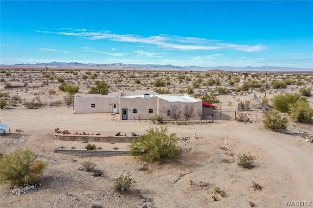 birds eye view of property with a desert view and a mountain view