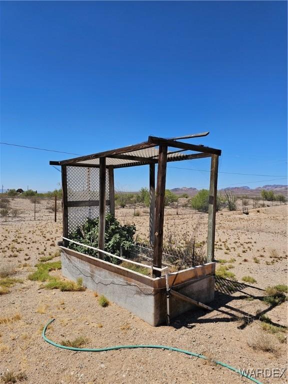 view of community featuring a rural view and a vegetable garden